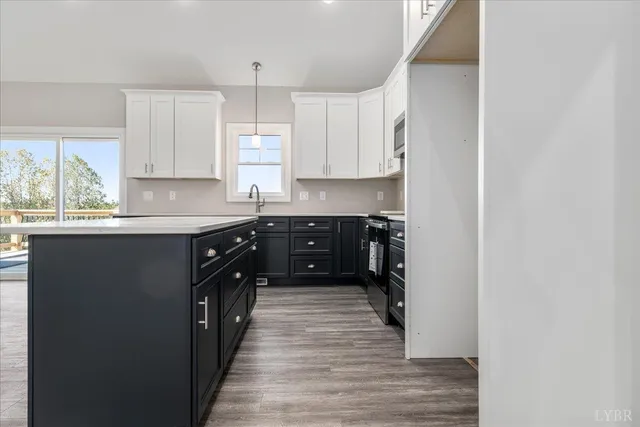 a kitchen with stainless steel appliances granite countertop a sink a stove and cabinets