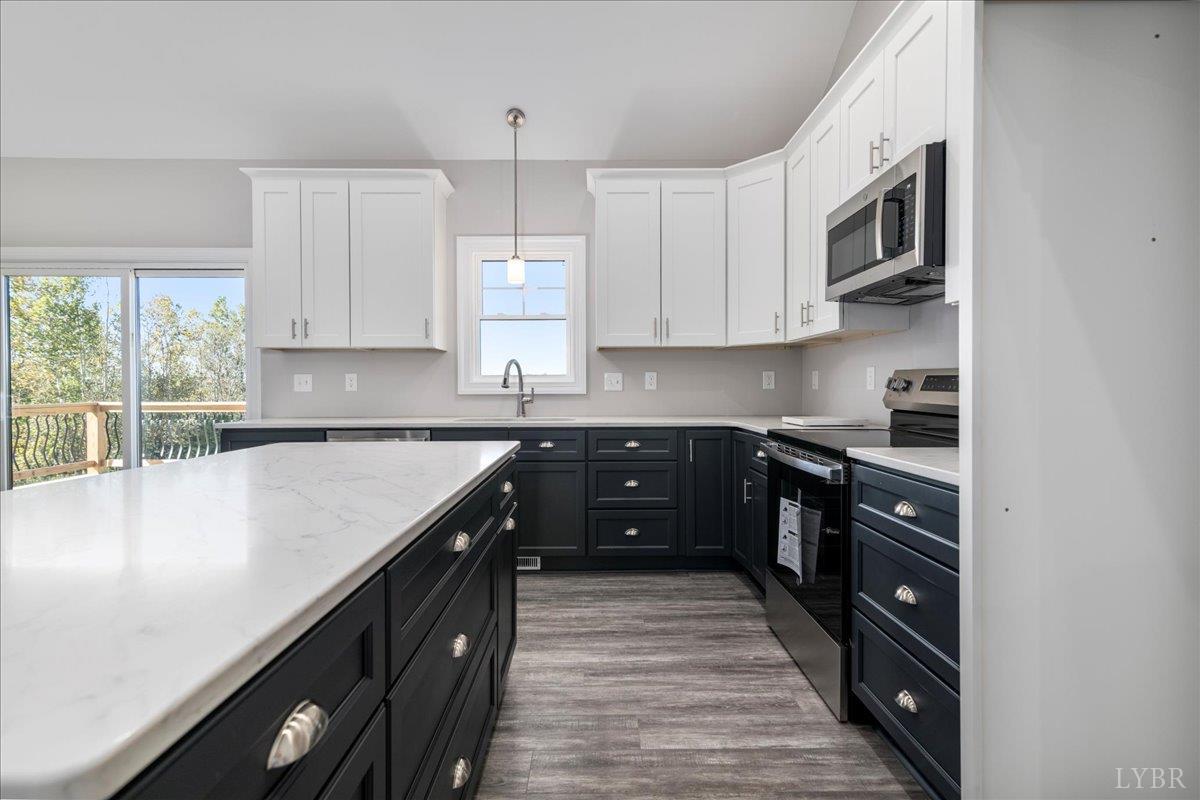 9830 Leesville Road Evington, VA 24550 - Photo 12 of 33 a kitchen with stainless steel appliances granite countertop a sink stove and cabinets