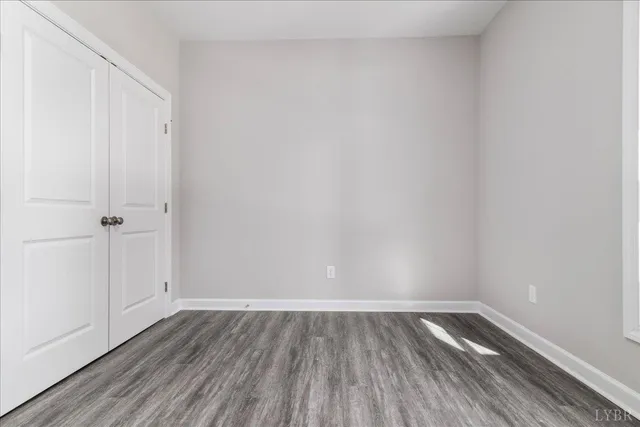 a view of an empty room and wooden floor