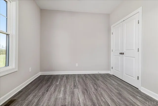 a view of a room with wooden floor and white walls