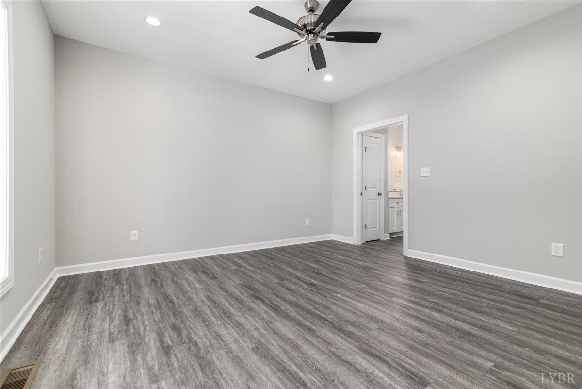 9830 Leesville Road Evington, VA 24550 - Photo 24 of 33 an empty room with wooden floor and windows