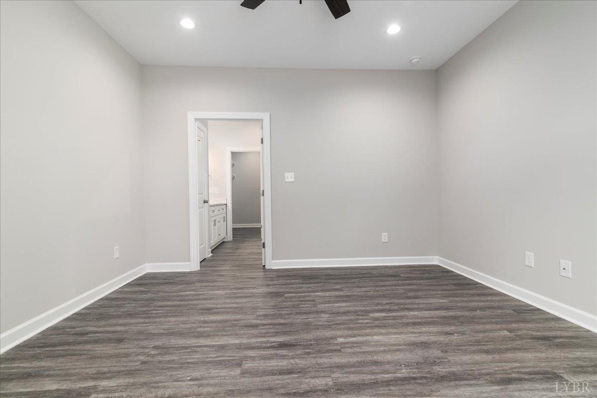 9830 Leesville Road Evington, VA 24550 - Photo 25 of 33 a view of an empty room with wooden floor and a window