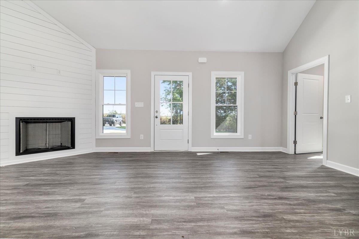 9830 Leesville Road Evington, VA 24550 - Photo 7 of 33 a view of an empty room with wooden floor and a window
