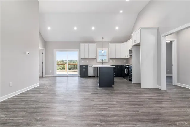 a large kitchen with stainless steel appliances granite countertop a stove and a refrigerator