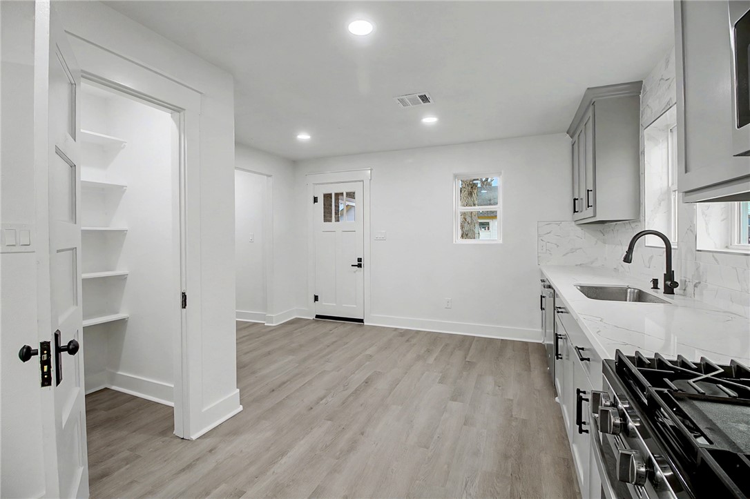 902 Post Oak Street Hearne, TX 77859 - Photo 13 of 26 a view of a kitchen with a sink and wooden floor