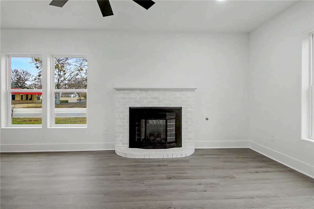 902 Post Oak Street Hearne, TX 77859 - Photo 14 of 26 a view of an empty room with a window and fireplace