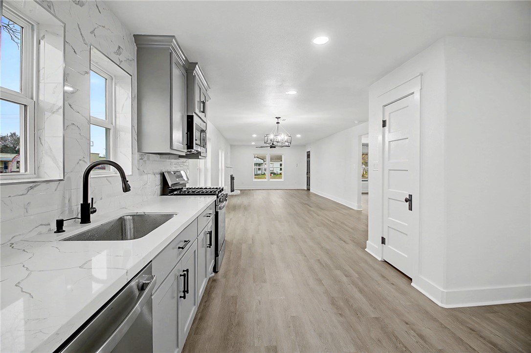 902 Post Oak Street Hearne, TX 77859 - Photo 15 of 26 a kitchen with cabinets and wooden floor