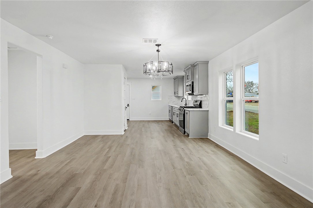 902 Post Oak Street Hearne, TX 77859 - Photo 16 of 26 a kitchen with granite countertop a stove and a refrigerator