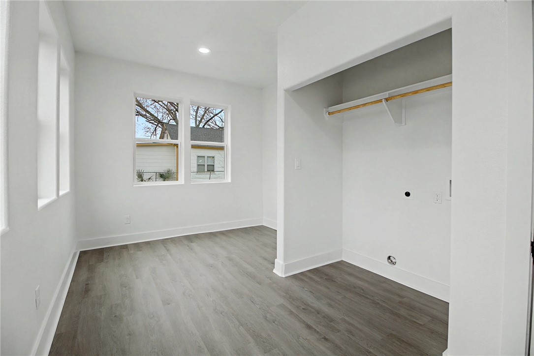 902 Post Oak Street Hearne, TX 77859 - Photo 22 of 26 a view of an empty room with wooden floor and a window