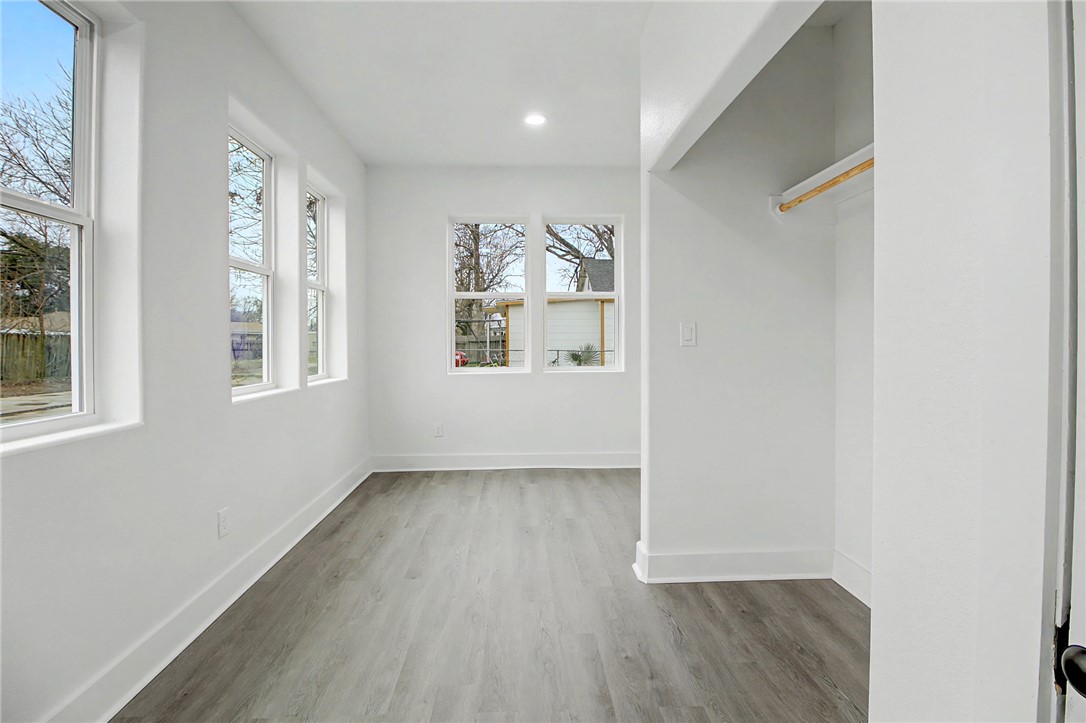 902 Post Oak Street Hearne, TX 77859 - Photo 23 of 26 an empty room with wooden floor and windows