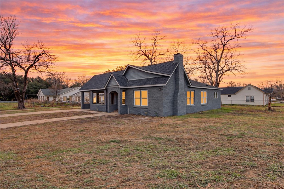 902 Post Oak Street Hearne, TX 77859 - Photo 3 of 26 a view of a big house with a big yard and large trees