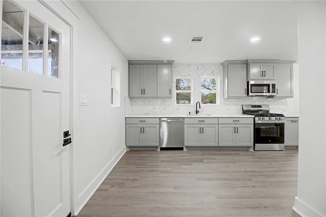 902 Post Oak Street Hearne, TX 77859 - Photo 9 of 26 a kitchen with stainless steel appliances a sink and cabinets