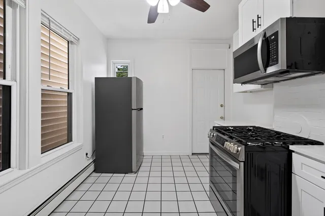 a kitchen with stainless steel appliances granite countertop a refrigerator and a stove top oven