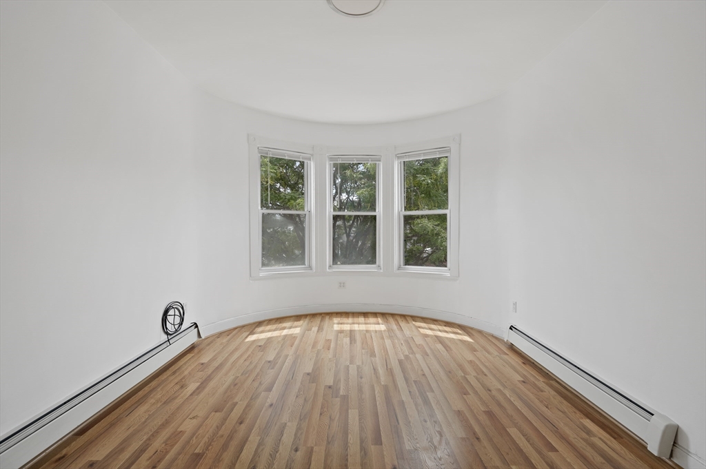 194 Emerson Street Boston, MA 02127 - Photo 12 of 18 a view of a room with wooden floor and windows