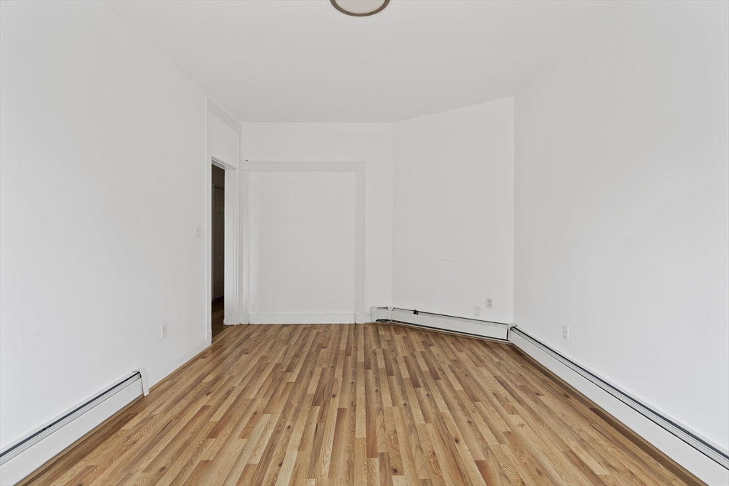 194 Emerson Street Boston, MA 02127 - Photo 13 of 18 a view of a room with wooden floor