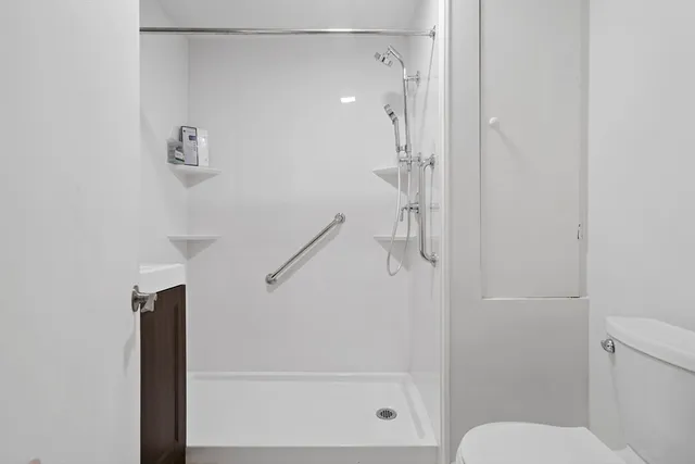 a bathroom with a shower and toilet
