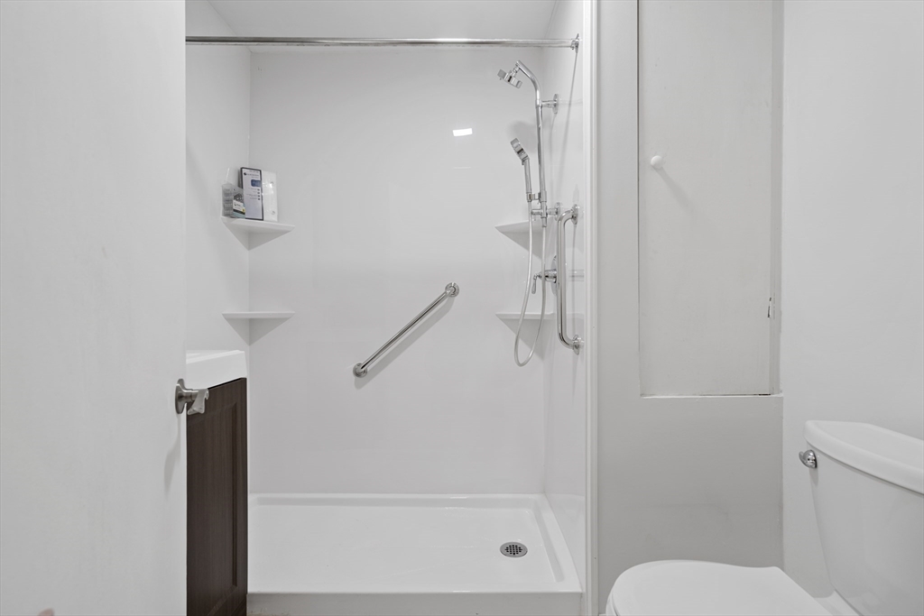 194 Emerson Street Boston, MA 02127 - Photo 16 of 18 a bathroom with a shower and toilet