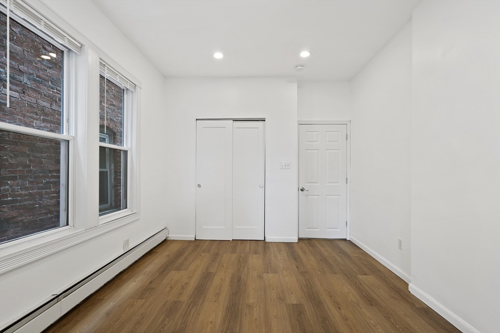 194 Emerson Street Boston, MA 02127 - Photo 17 of 18 a view of empty room with wooden floor and fan