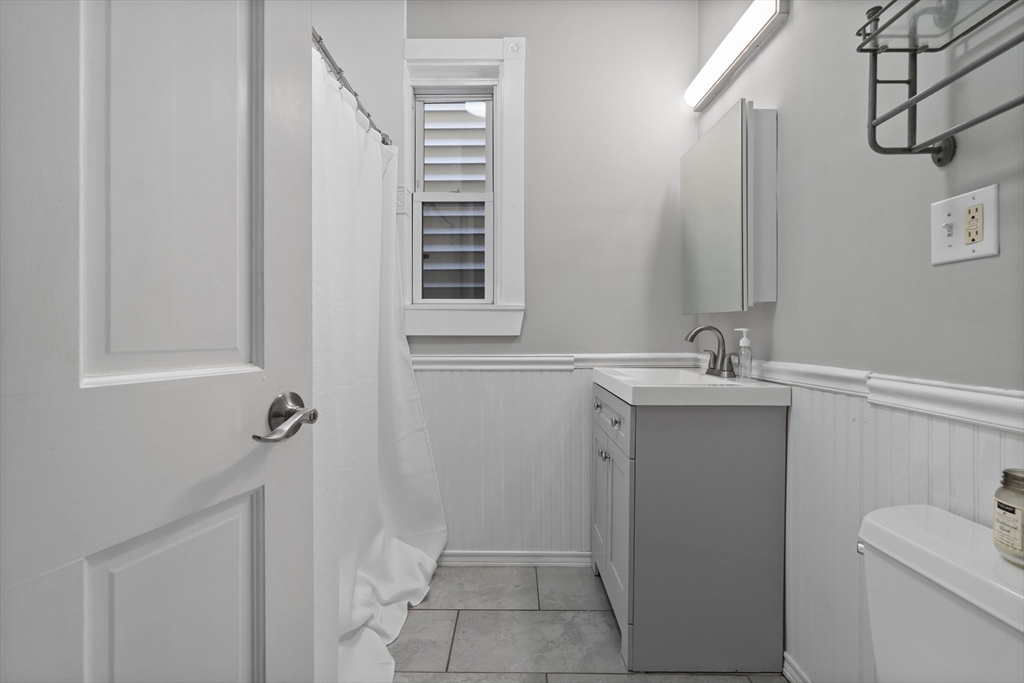 194 Emerson Street Boston, MA 02127 - Photo 7 of 18 a bathroom with a sink a toilet and shower