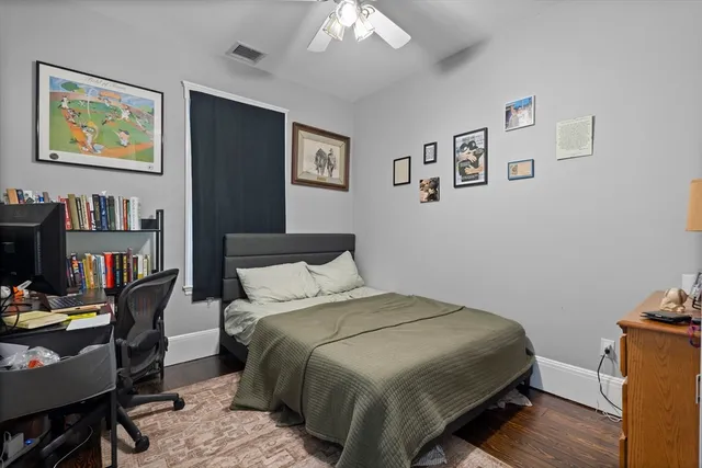 a bedroom with a bed and a bookshelf
