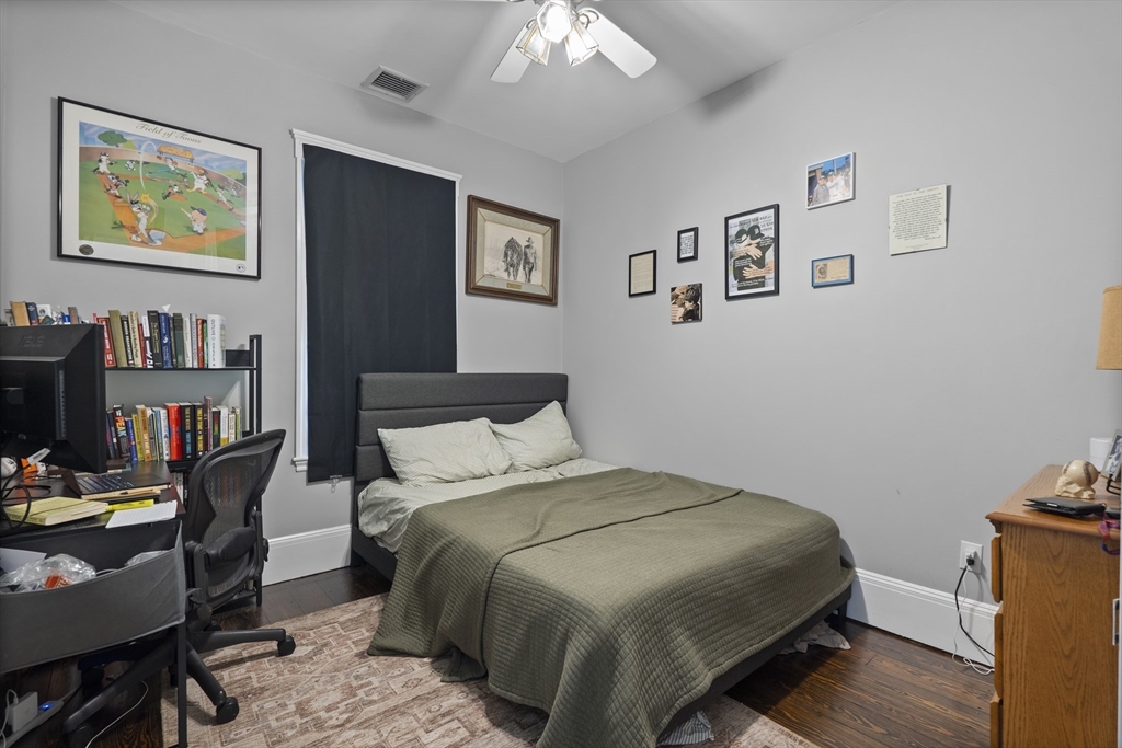 194 Emerson Street Boston, MA 02127 - Photo 8 of 18 a bedroom with a bed and a bookshelf