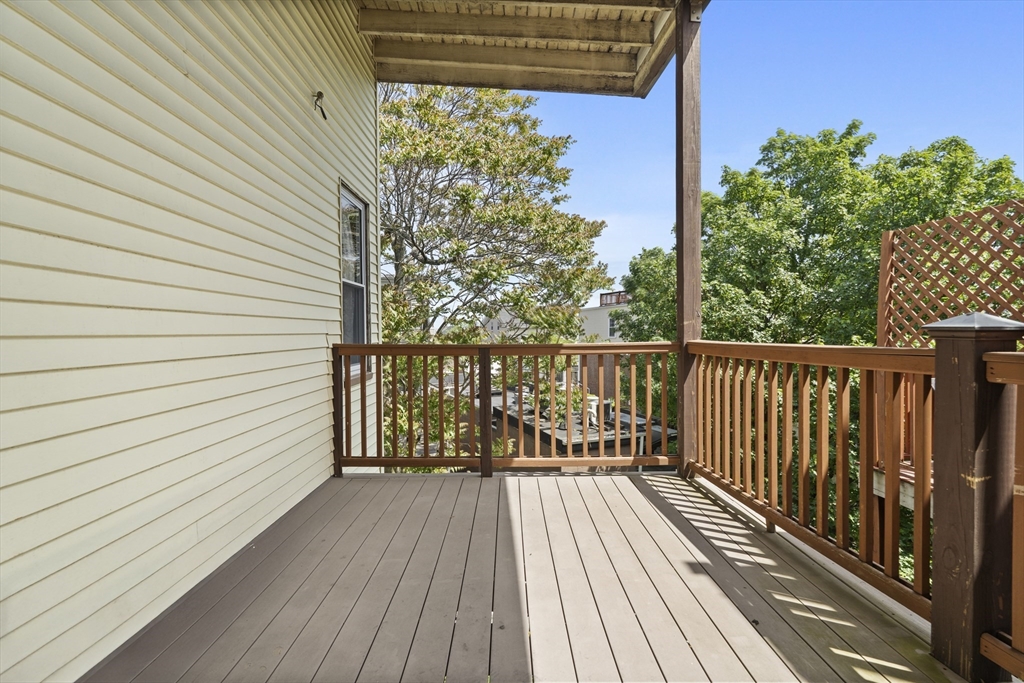 194 Emerson Street Boston, MA 02127 - Photo 9 of 18 a view of balcony with wooden floor and fence and a floor to ceiling window