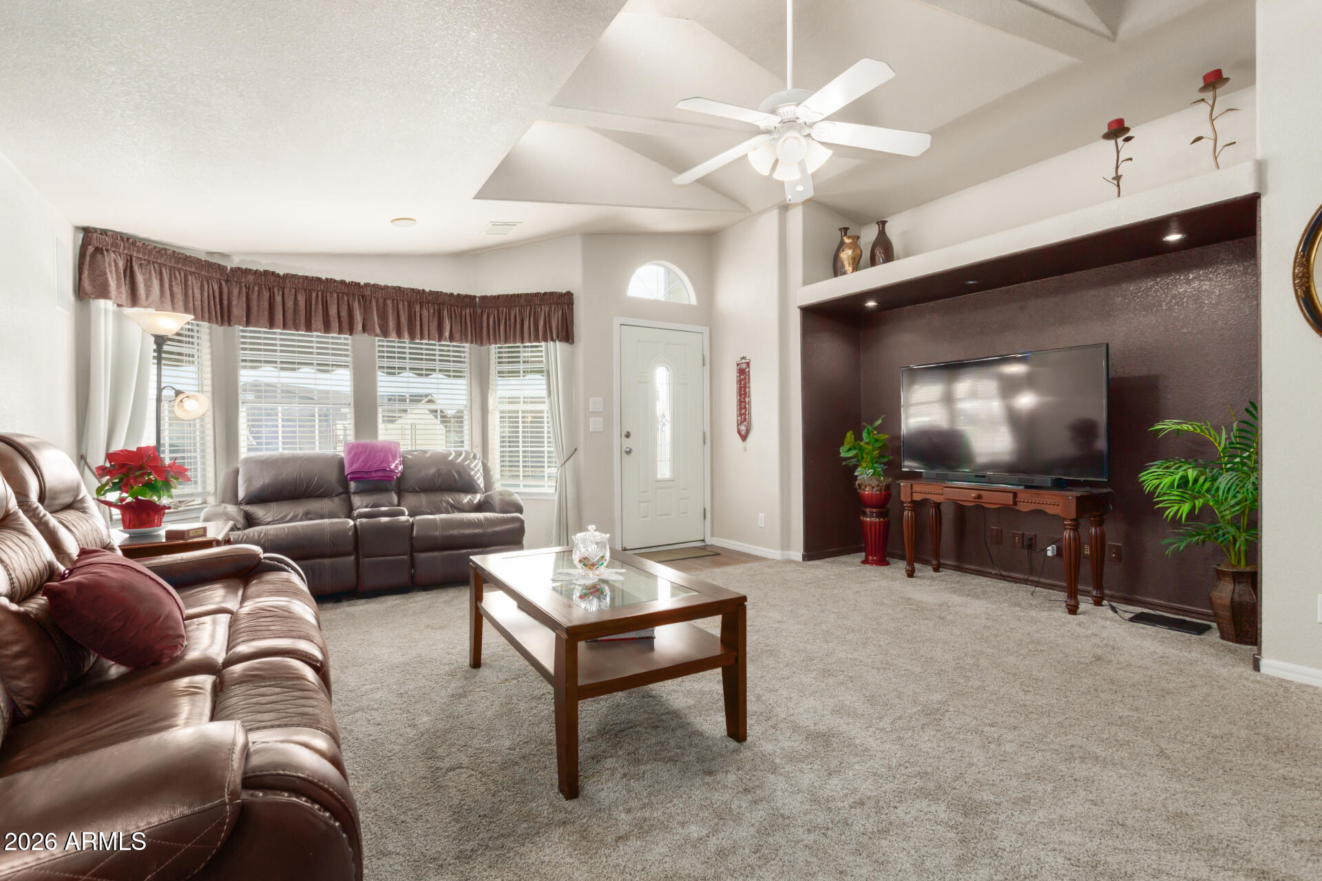 3301 South Goldfield Road, Unit 4086 Apache Junction, AZ 85119 - Photo 16 of 42 a living room with furniture and a flat screen tv