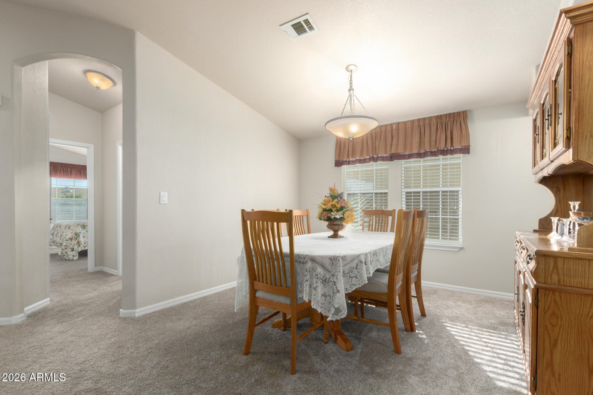 3301 South Goldfield Road, Unit 4086 Apache Junction, AZ 85119 - Photo 20 of 42 a view of a dining room with furniture and a chandelier