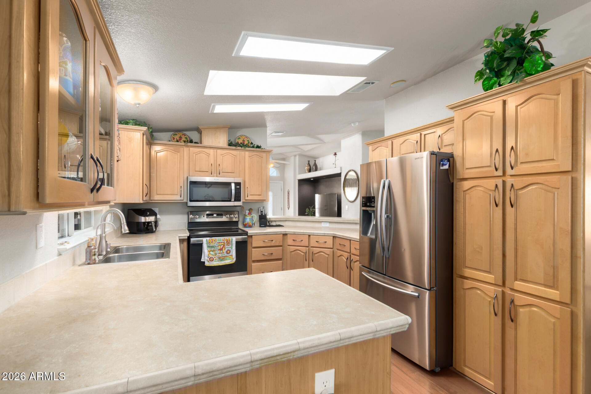 3301 South Goldfield Road, Unit 4086 Apache Junction, AZ 85119 - Photo 21 of 42 a kitchen with stainless steel appliances a refrigerator sink and microwave