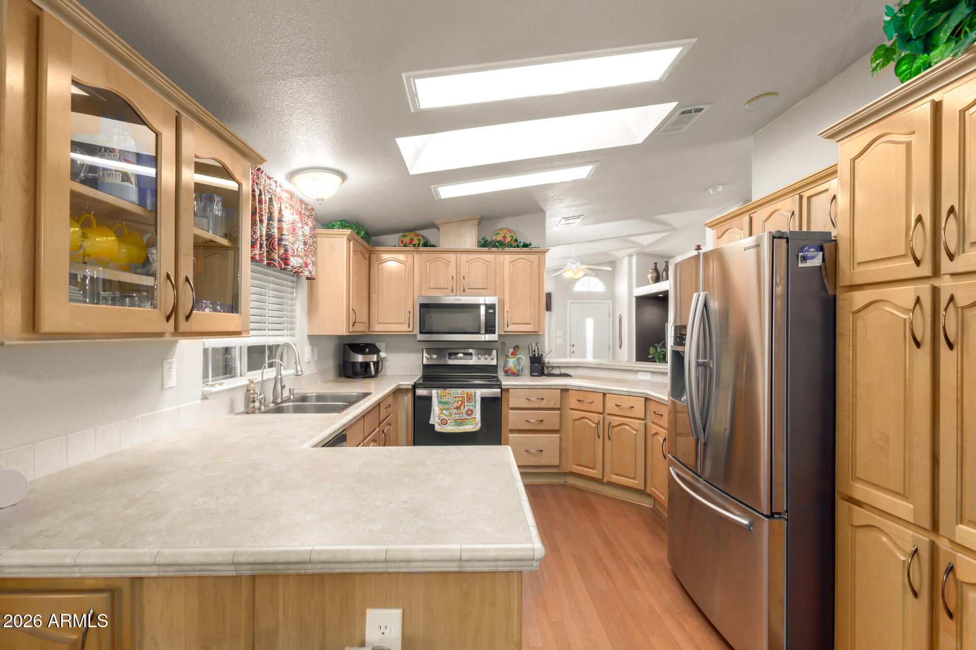 3301 South Goldfield Road, Unit 4086 Apache Junction, AZ 85119 - Photo 23 of 42 a kitchen with granite countertop a refrigerator stove and sink