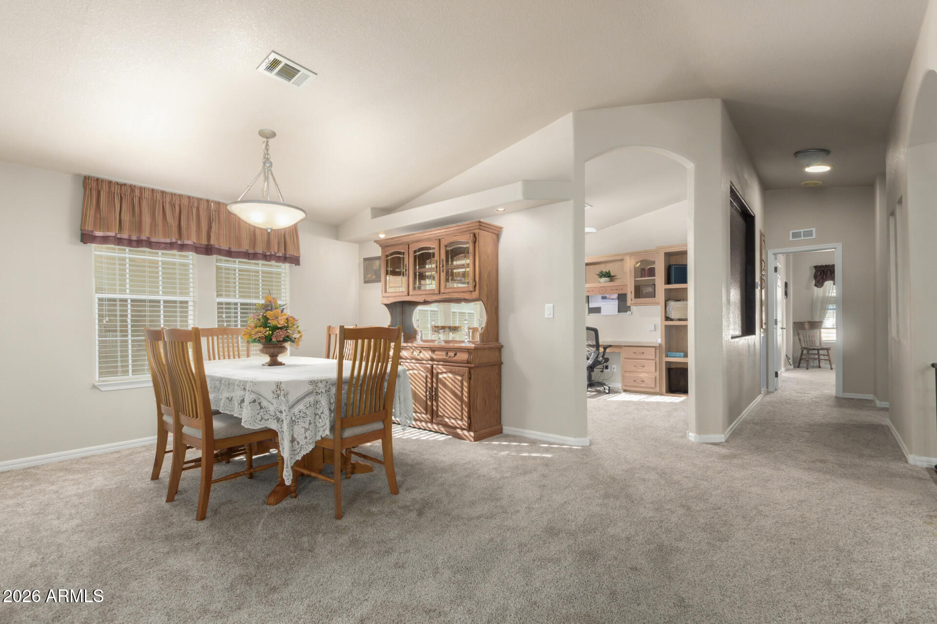 3301 South Goldfield Road, Unit 4086 Apache Junction, AZ 85119 - Photo 4 of 42 a view of a dining room and livingroom with furniture