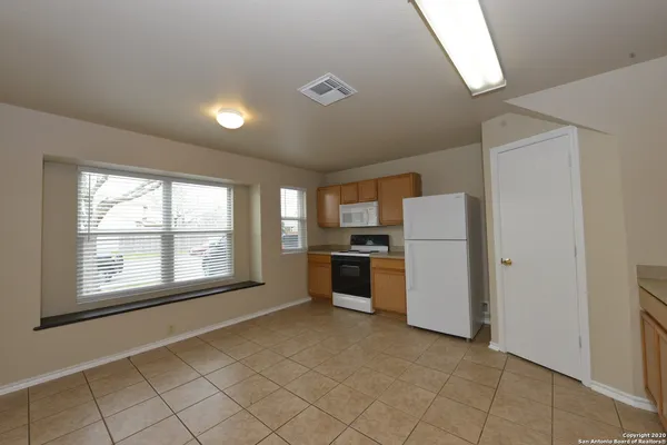 a view of a kitchen with a sink dishwasher and a refrigerator