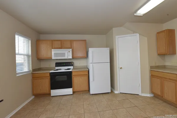 a kitchen with cabinets and stainless steel appliances