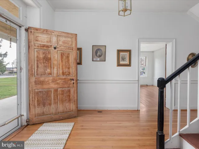 a view of front door with wooden floor