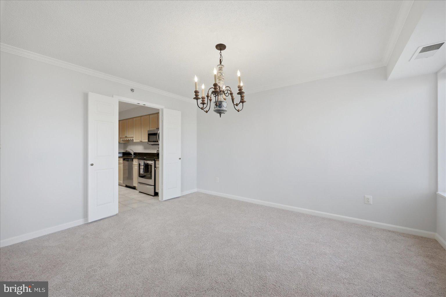 19385 Cypress Ridge Terrace, Unit 514 Leesburg, VA 20176 - Photo 30 of 81 Dining Room with statement light fixture