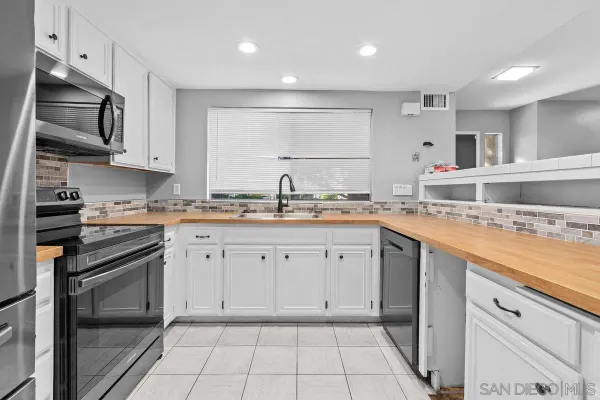 a kitchen with a sink stove and cabinets