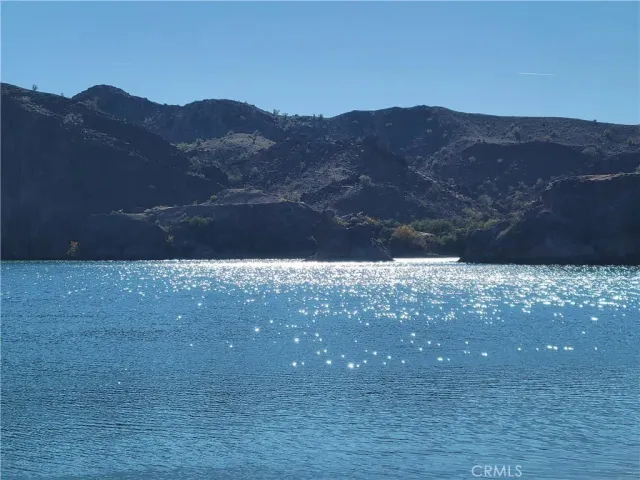 a view of a house with a yard and large tree