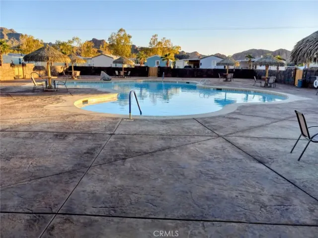 a swimming pool with outdoor seating and yard