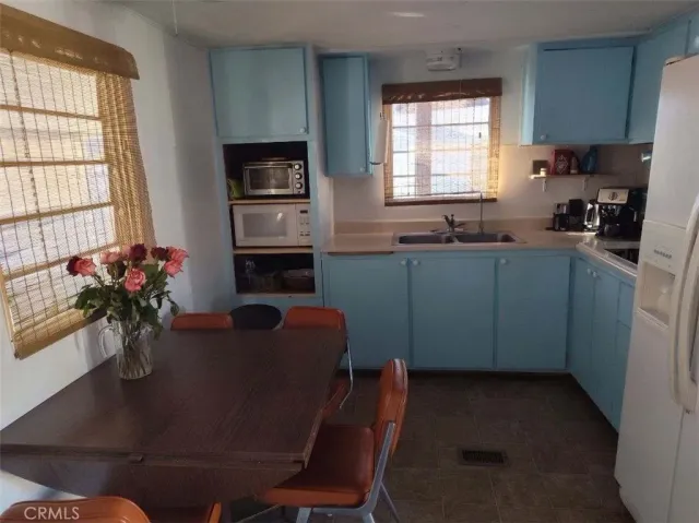 a dining room with furniture window and a kitchen