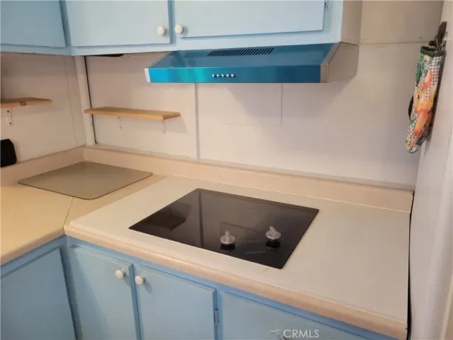 a kitchen with a cabinets and white appliances
