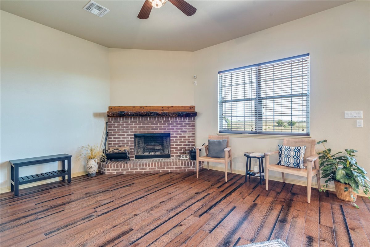 909 County Road 342 Granger, TX 76530 - Photo 13 of 37 Family room with wood burning fireplace and wall of windows