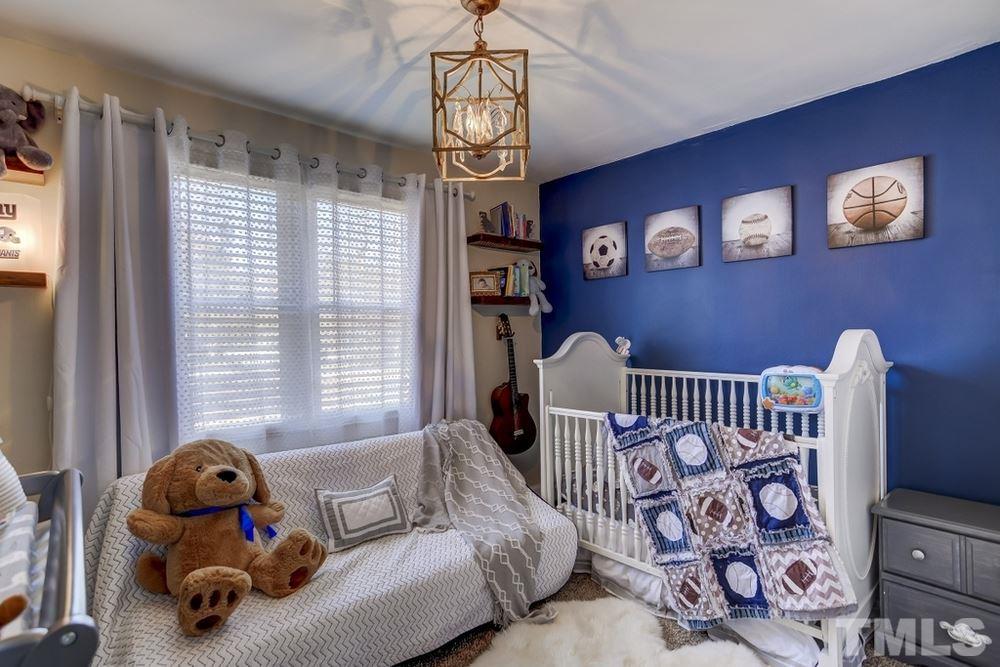 424 Colleton Road Raleigh, NC 27610 - Photo 14 of 16 a bedroom with furniture and a window
