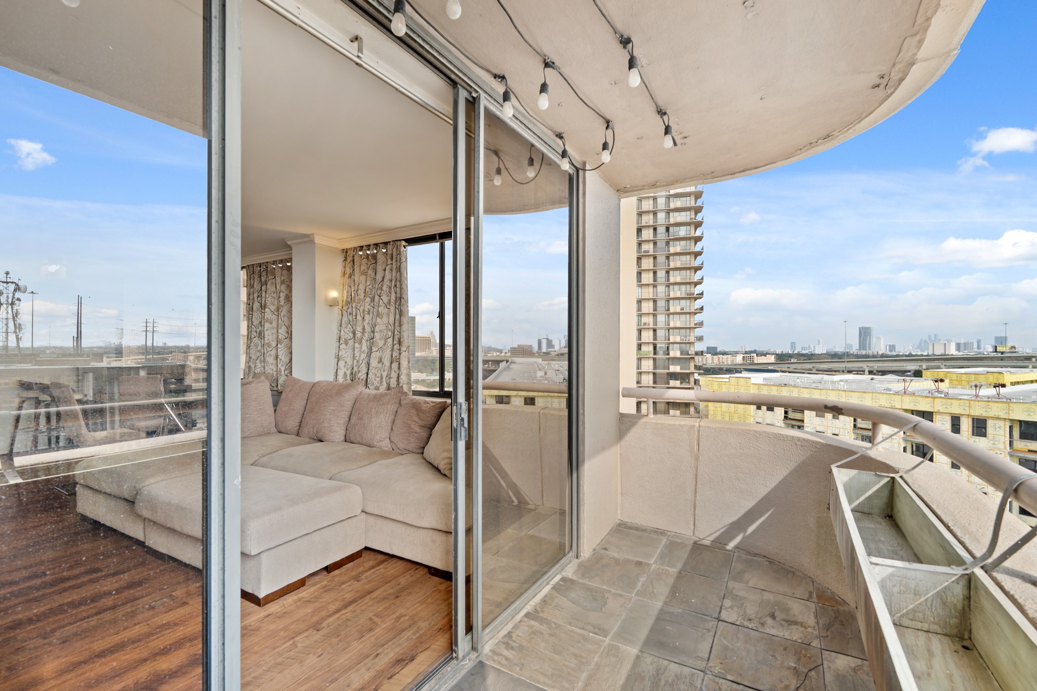 Private balcony with room for seating and open views of the surrounding area.