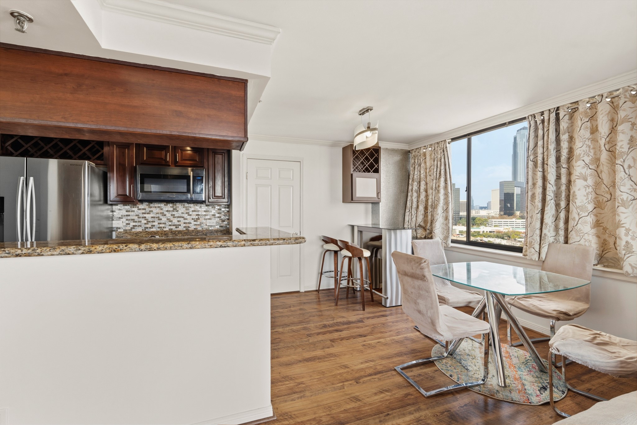 3525 Sage Road, Unit 1204 Houston, TX 77056 - Photo 14 of 25 View from the kitchen toward the dining area, highlighting open sightlines and natural light.