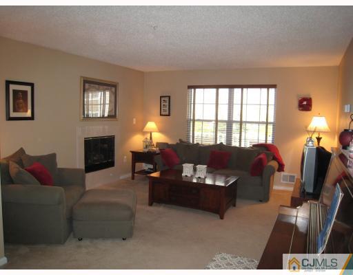 115 Inverness Drive Edison, NJ 08820 - Photo 2 of 10 a living room with furniture and a fireplace