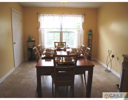 115 Inverness Drive Edison, NJ 08820 - Photo 4 of 10 a view of a dining room with furniture window and outside view
