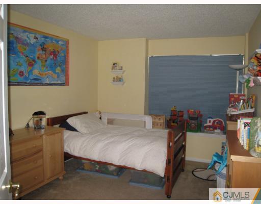 115 Inverness Drive Edison, NJ 08820 - Photo 7 of 10 a bedroom with a bed and furniture