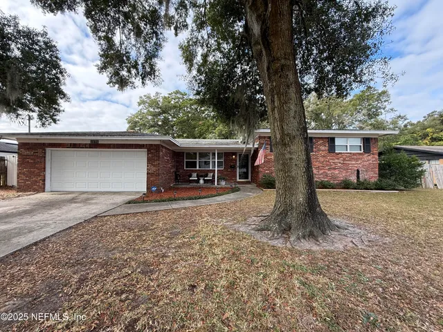 a front view of house with a garden