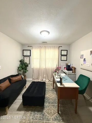 a living room with furniture potted plant and a window