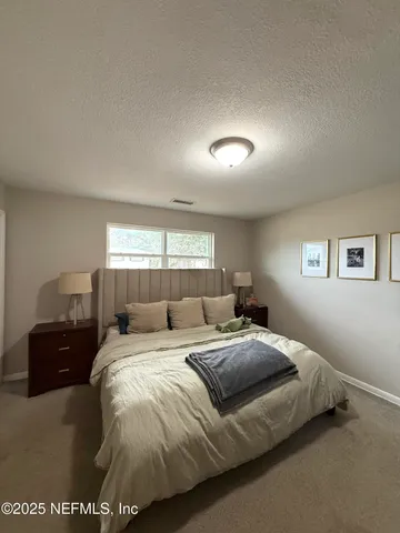 a bathroom with a granite countertop toilet sink and mirror